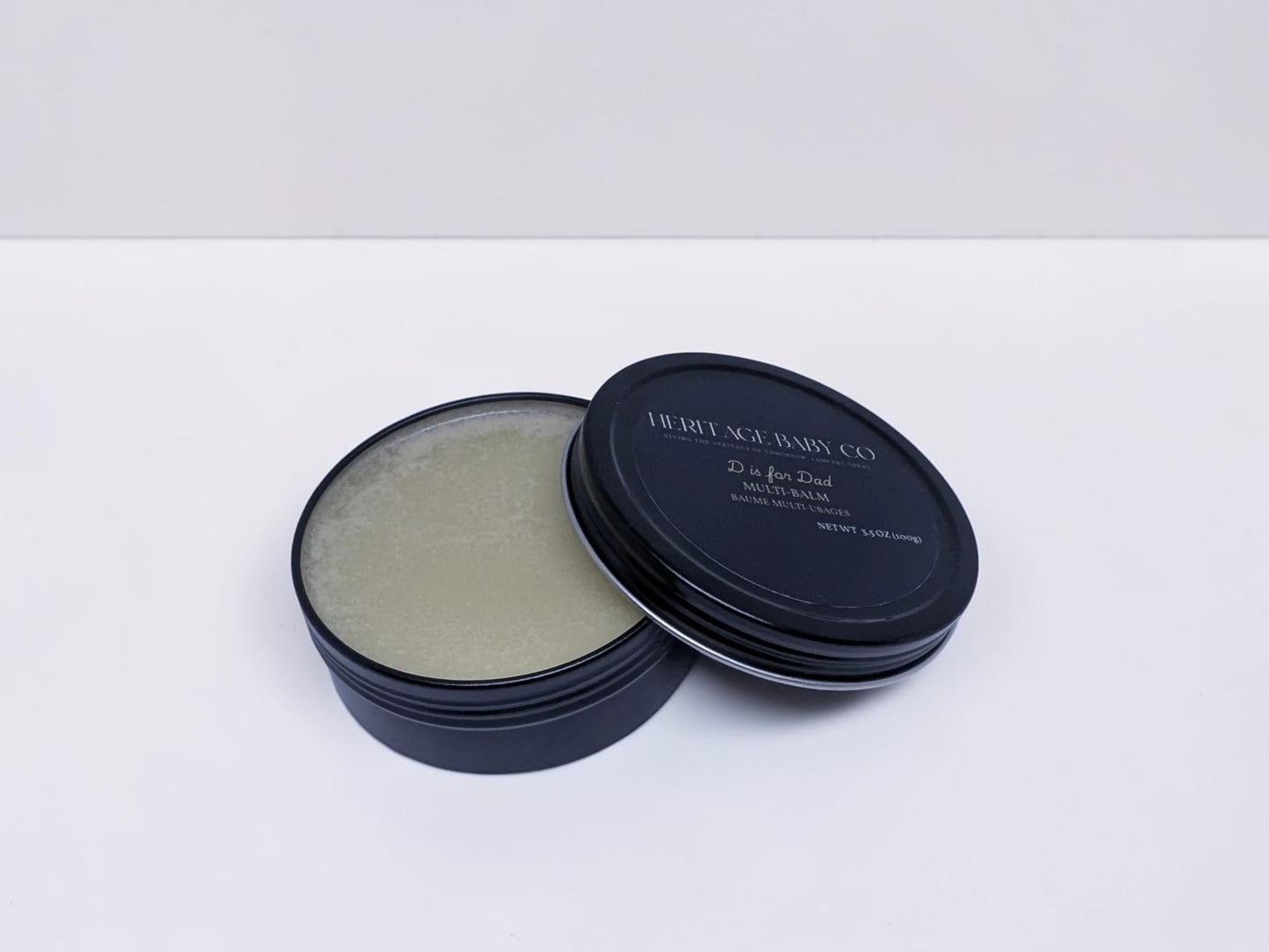 Heritage Baby Co. D is for Dad tallow multi-balm in a black tin for skin, beard, and hands.