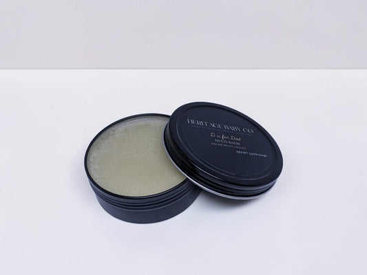 Heritage Baby Co. D is for Dad tallow multi-balm in a black tin for skin, beard, and hands.